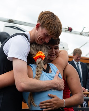 Competitors hug